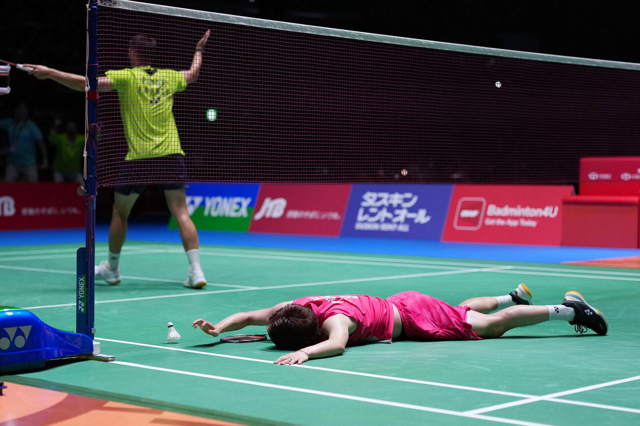 男子シングルス決勝で敗れ寝転ぶ渡辺航貴。後方は優勝のフランスのクリスト・ポポフ（撮影・滝沢徹郎）