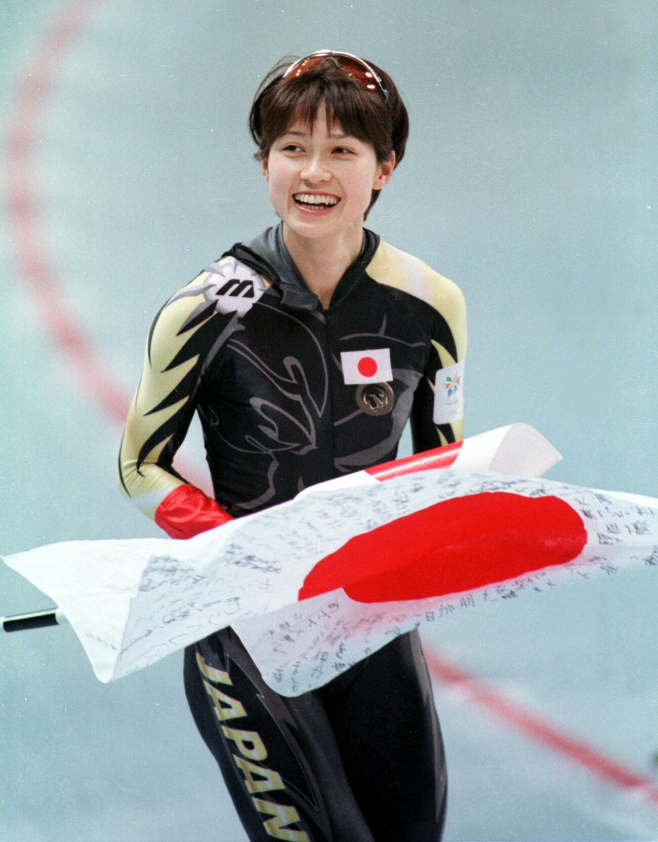 長野五輪スピードスケート女子500メートル2日目（2回目）　銅メダルを獲得し日の丸を手に満面の笑みでウイニングランを行う岡崎朋美（1998年2月14日）