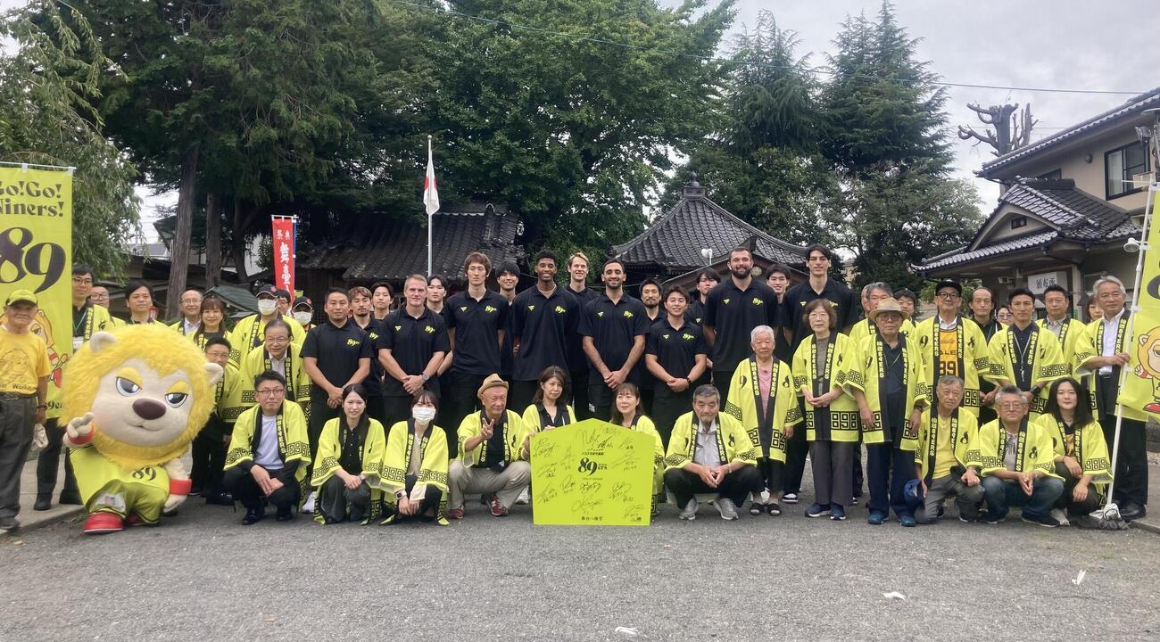 「バスケのまち長町」団結式を終え集合写真に納まる仙台89ERSと参加者ら（撮影・高橋香奈）
