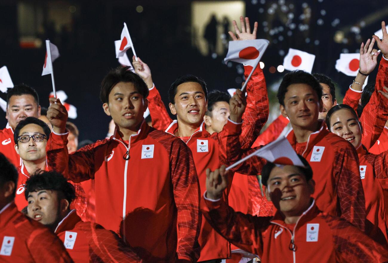 開会式で入場行進する車いすテニス男子の小田凱人（中央）ら日本選手団＝18日、パロマ瑞穂スタジアム（共同）