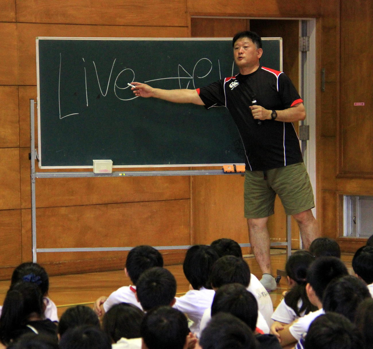 講演会で「LIVE」と「EVIL」の意味について説明する今泉氏